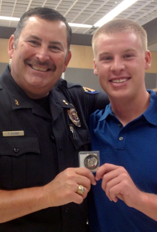 Round Rock Police Department Assistant Chief of Police Troy Evans (left) and Blake Pryor after the presentation of the chiefs Challenge Coin on July 23.