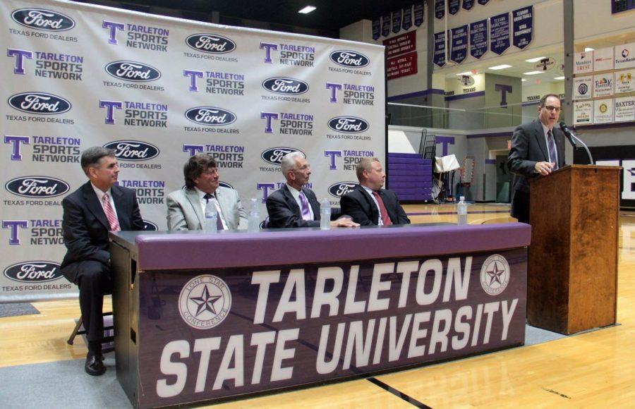 Tarleton Athletic Director Lonn Reisman (standing) addresses the crowd during Wednesdays press conference announcing the five-year partnership with North Texas Ford Dealers as sponsor of the Tarleton Sports Network. Seated (l-r) are past president of the North Texas Ford Dealers board Charlie Gilchrist, TexStar Ford owner Doug Montgomery, Tarleton President Dr. Dominic Dottavio and Assistant Athletic Director for Development and Major Gifts Casey Hogan.
