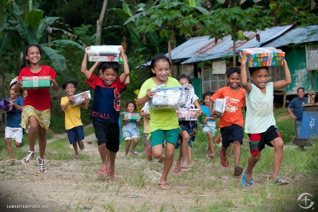 Children seen carrying their newly received Christmas packages.
