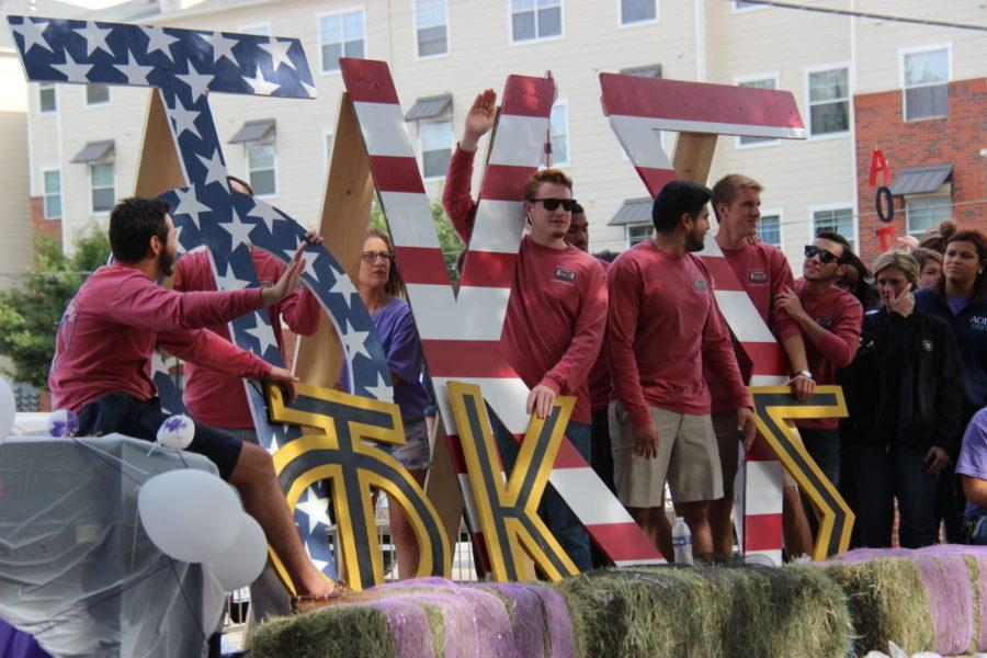 Members+of+Phi+Kappa+Sigma+and+Alpha+Omicron+Pi+rode+in+the+2015+homecoming+parade.