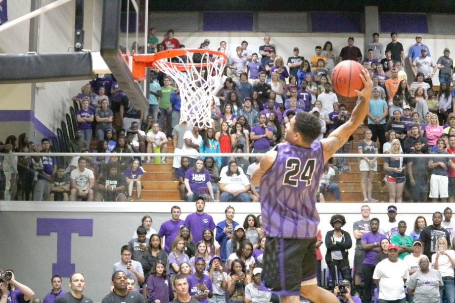 Michael Hardge going for a dunk during Midnight Madness
