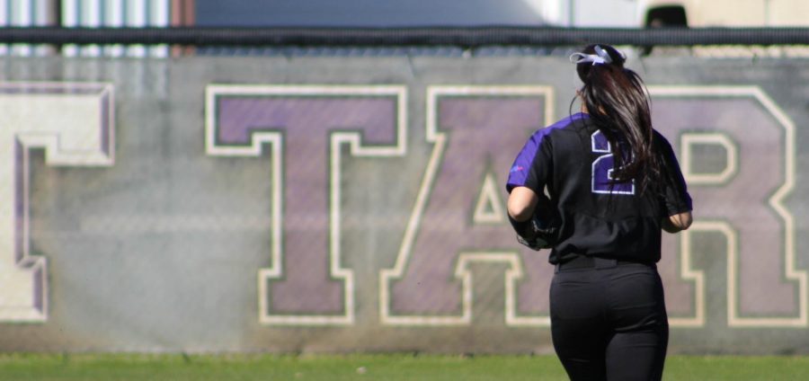 Jessica Lee runs back to the outfield after the play finishes. 