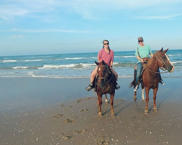 Madison White and her mom ride horse along the coast of the Gulf of Mexico with South Padre Island Adventure Park. 