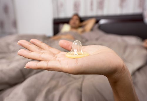 A condom in the palm of the hand. 