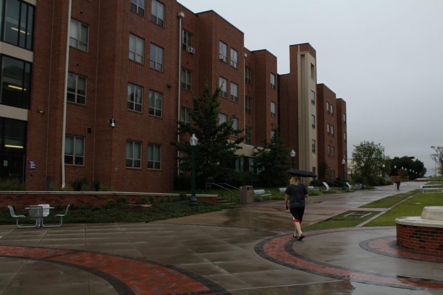 A student walks past Honors Hall while trying to stay dry during the rain we experienced Sept. 1.