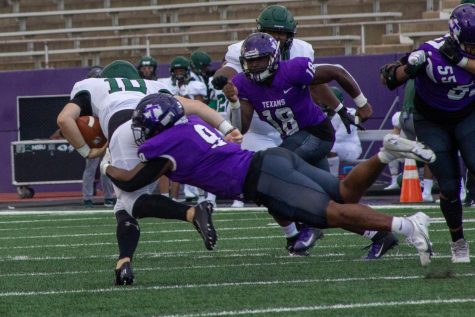 ChadWick Thibodeaux tackling an opponent during the Northeastern state football game on March 27, 2021.