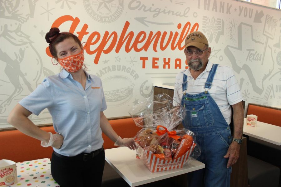 Billy Cowen receiving a gift basket from Whataburger Operating Partner, Minden Sigman, for being the first dine in customer in the new Whataburger store on Washington Street. 